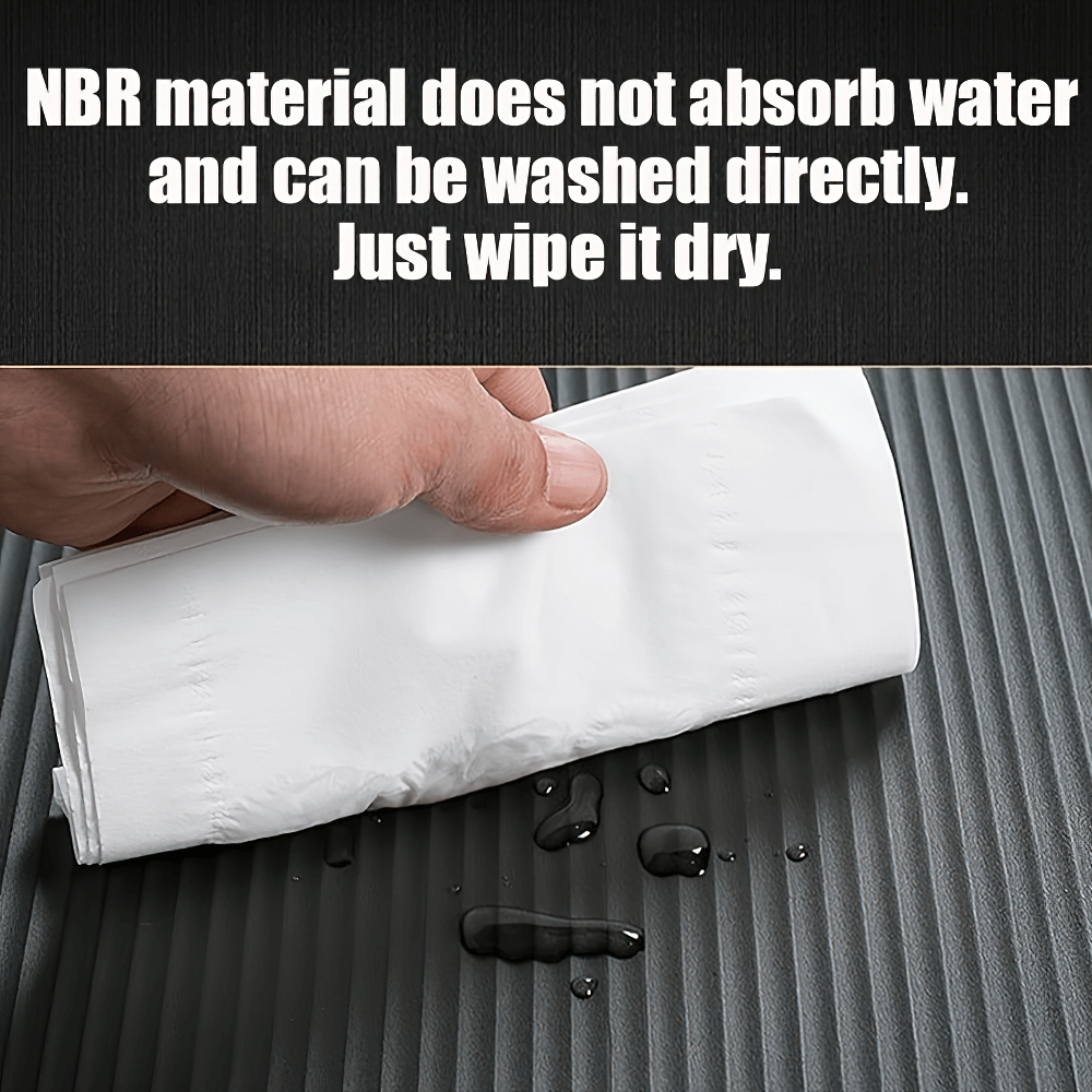 Person wiping water off non-slip exercise mat with a towel, highlighting its easy-to-clean NBR material.