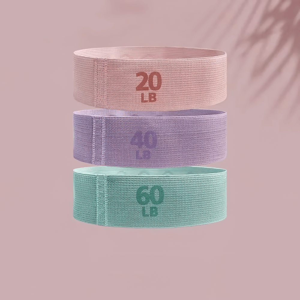 Fabric resistance bands set in pink, purple, and teal offering 20LB, 40LB, and 60LB resistance levels for workouts.