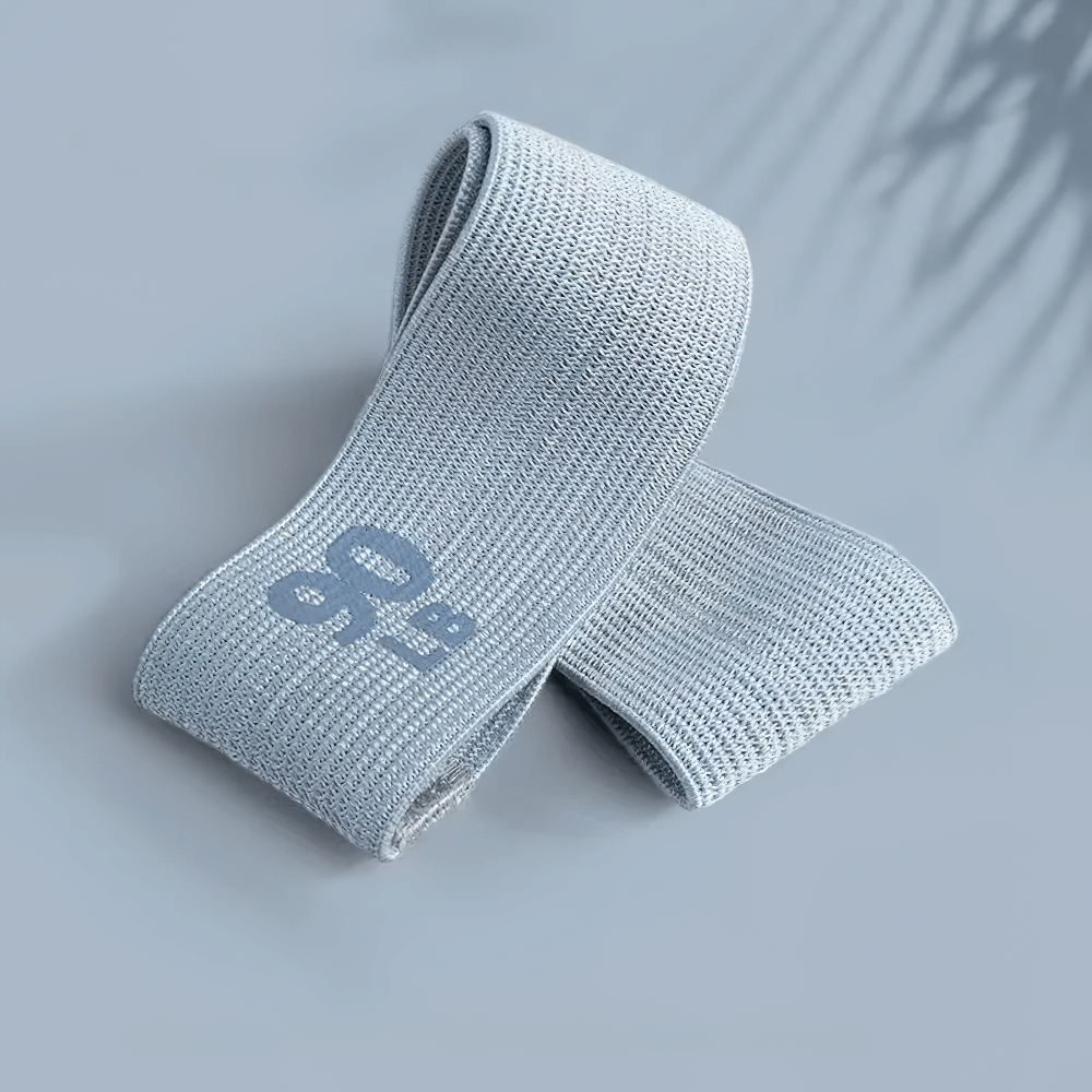 Light blue elastic resistance band for yoga and strength training, offering progressive resistance for home gym workouts.