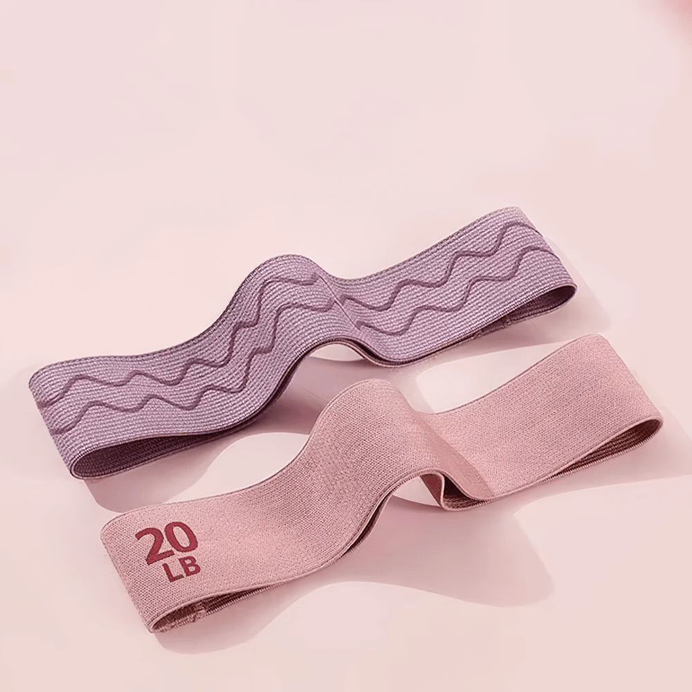 Pink and purple fabric resistance bands for home gym, shown in 20LB strength, perfect for Pilates and hip training workouts.