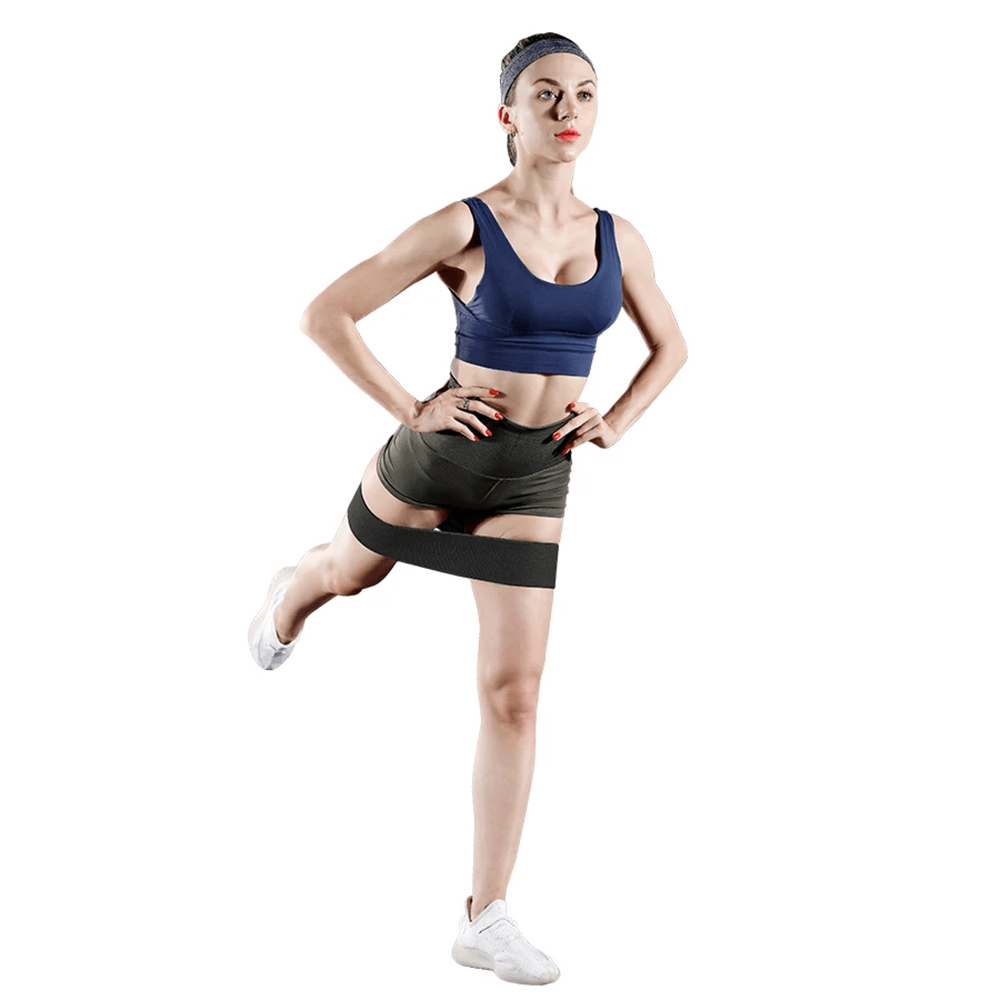 Woman exercising with fabric resistance hip bands for glute and thigh activation, perfect for yoga, pilates, and strength training.