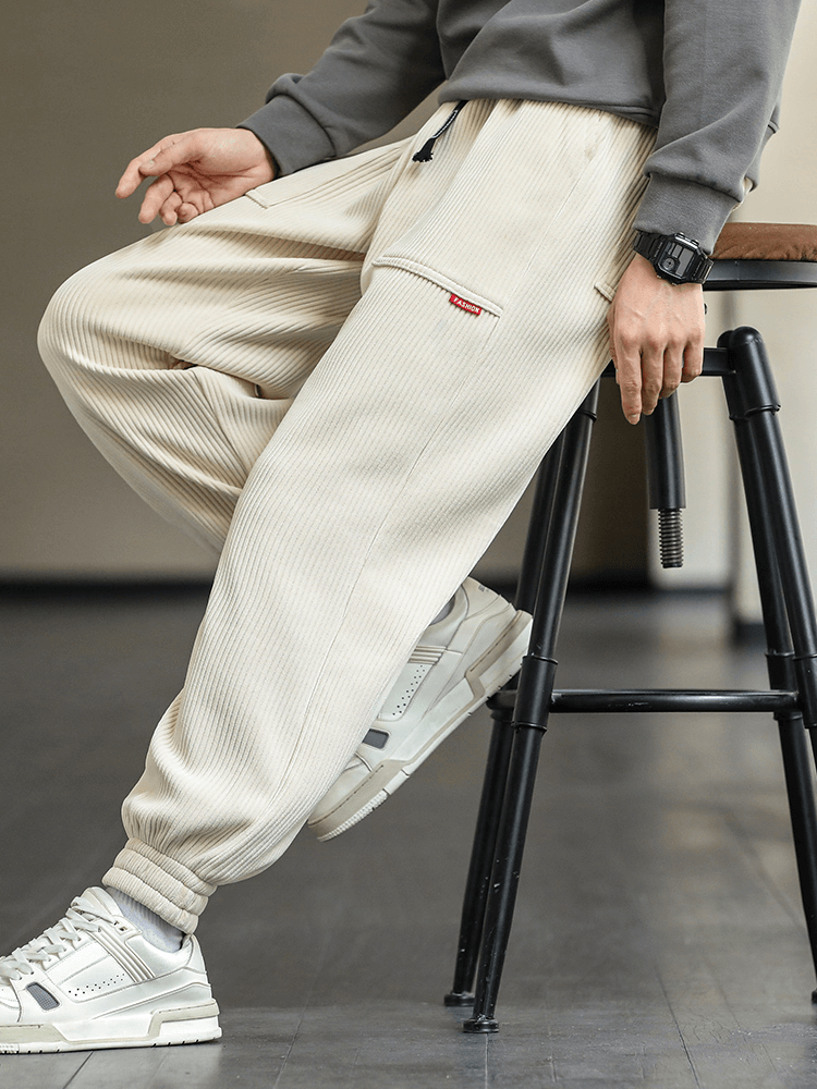 Men's fashion corduroy sweatpants with elastic hem, loose fit joggers, beige, casual style for comfort and style.