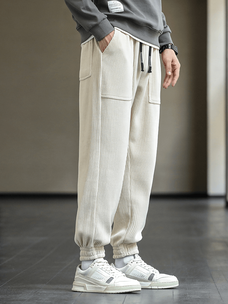 Men's Fashion Elastic Hem Corduroy Sweatpants with drawstring, loose fit, light color, styled with sneakers and a casual top