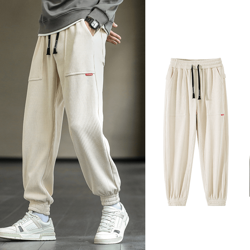 Men's fashion loose corduroy sweatpants with elastic hem and drawstring, showcasing stylish casual jogger design.