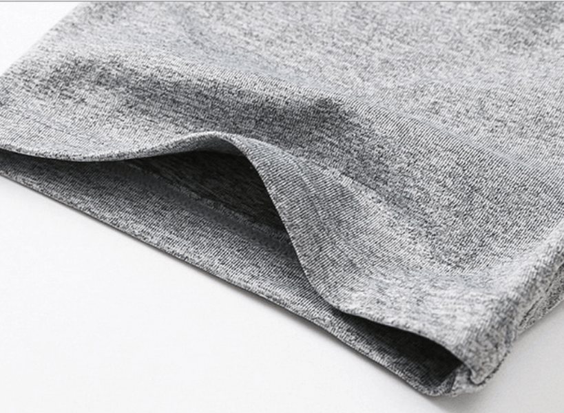 Close-up of a grey, breathable, elastic men's V-neck t-shirt sleeve, showing soft fabric texture ideal for casual wear.