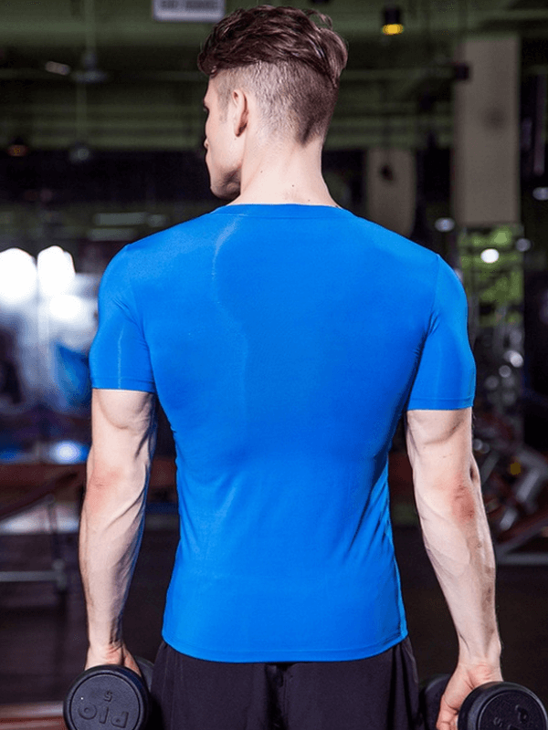 Man wearing a blue fashion elastic V-Neck short sleeve t-shirt, back view, holding dumbbells in a gym.