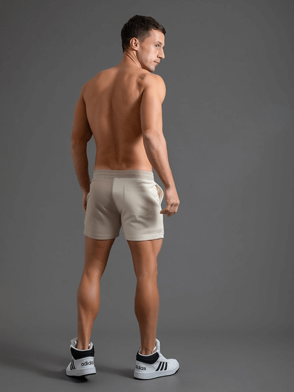 Man wearing fashion elastic waist cotton shorts, showcasing style and comfort. Perfect for sports and casual activities.