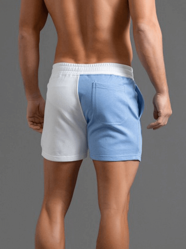 Men's cotton elastic waist two-color shorts with pockets, patchwork pattern, and drawstring closure; perfect for versatile activities.