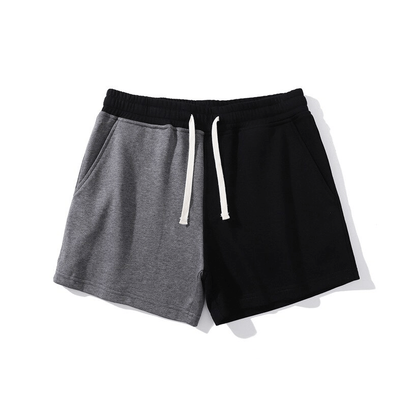 Men's fashion shorts with elastic waist, black and gray patchwork, cotton, drawstring closure, stylish and breathable design.