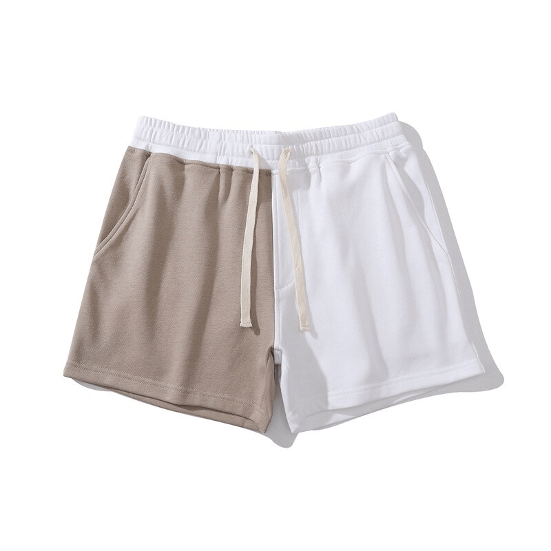 Men's fashion elastic waist two-color cotton shorts with pockets and drawstring, featuring a stylish patchwork design for versatile activities.