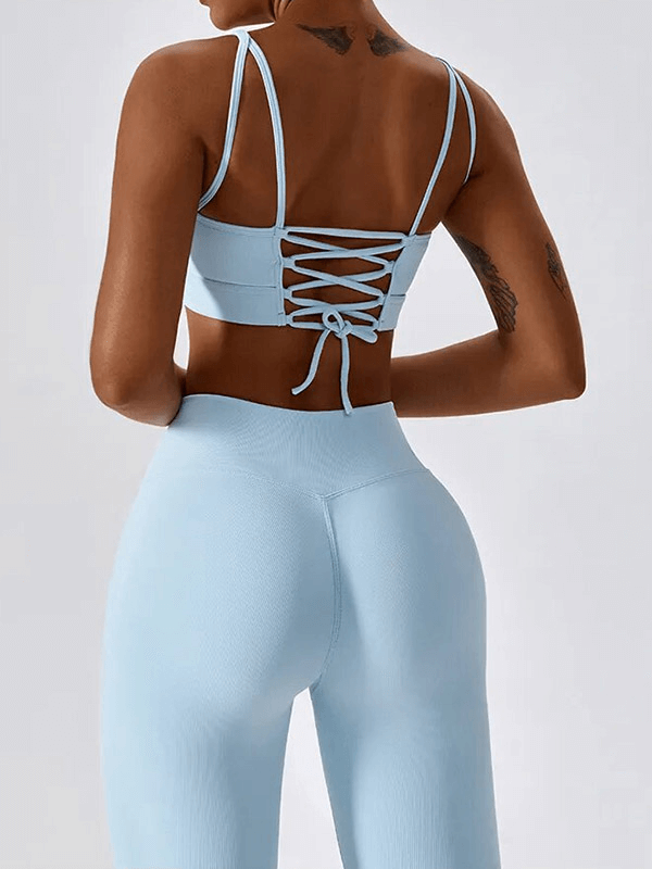 Back view of woman in blue seamless sports set SF1717, with lace-up detail, showcasing fitness in breathable and eco-friendly material.