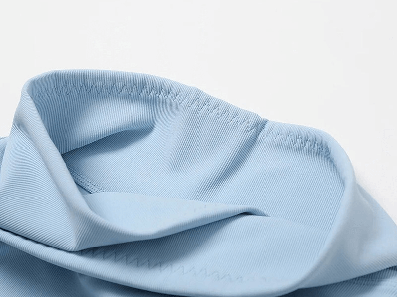 Close-up of blue seamless sports fabric in the Fashion Female 2pcs Set SF1717, highlighting high-tech nylon and spandex material.