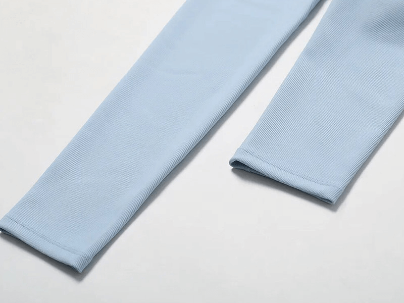 Close-up of light blue sleeves from Fashion Female Seamless Sports Set SF1717, highlighting breathable compressed fabric.