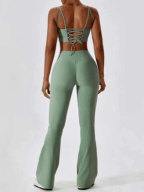 Back view of a woman wearing the Fashion Female 2pcs Seamless Sports Compressed Set in green, showcasing the lace-up sports bra and high-waisted leggings.