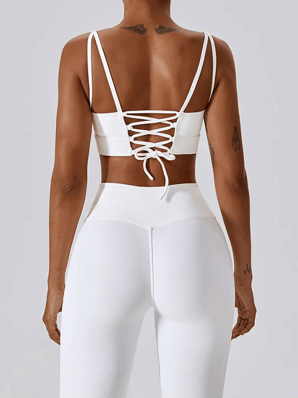 Back view of white seamless sports set with lace-up detail, highlighting breathable, eco-friendly fabric designed for women in active fitness routines.