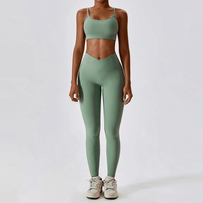 Woman in a green seamless sports set, featuring a high-tech nylon blend with compression and eco-friendly, quick dry technology.