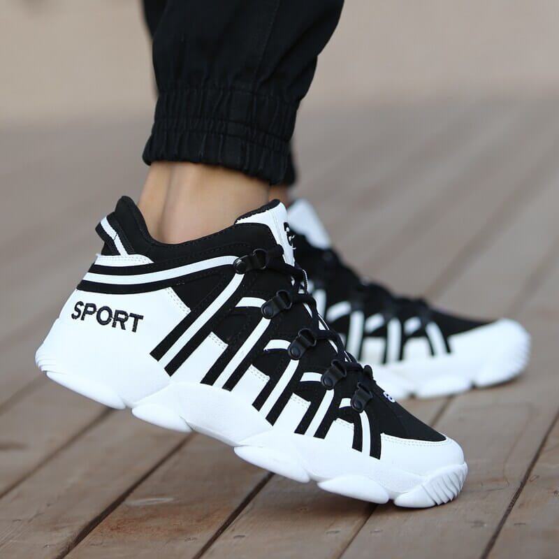 Unisex black and white lace-up sneakers for sports, featuring durable PU upper and rubber outsole with stylish design.