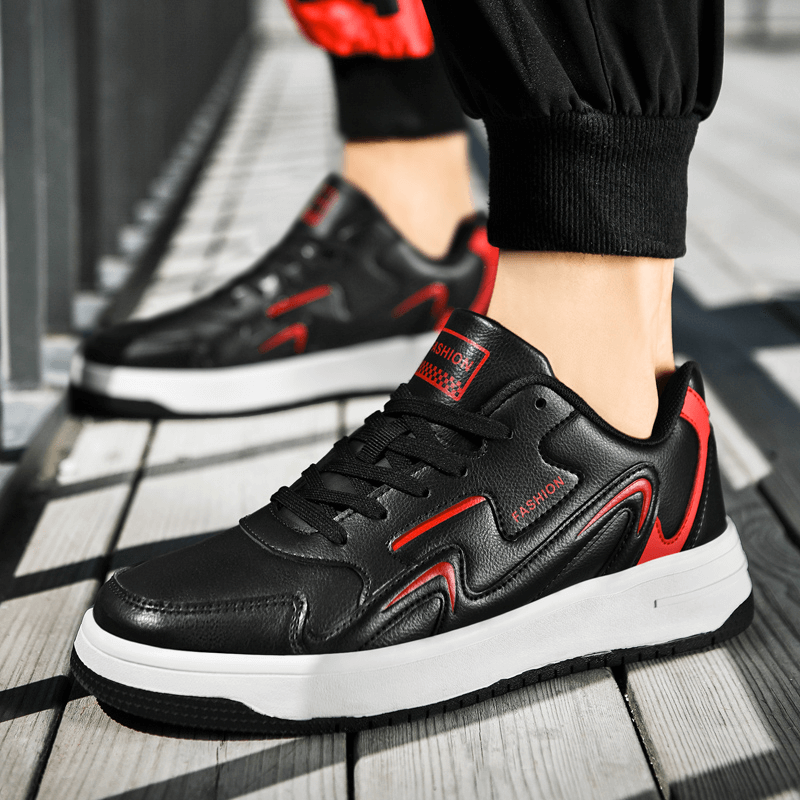 Modern unisex leather sneakers with lace-up design and red accents, perfect for casual outings and everyday comfort.