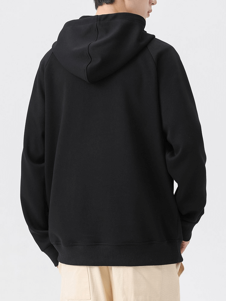 Back view of a man wearing a black Fashion Long Sleeves Half-Zip Hoodie with hood, showcasing its casual style and soft fabric.