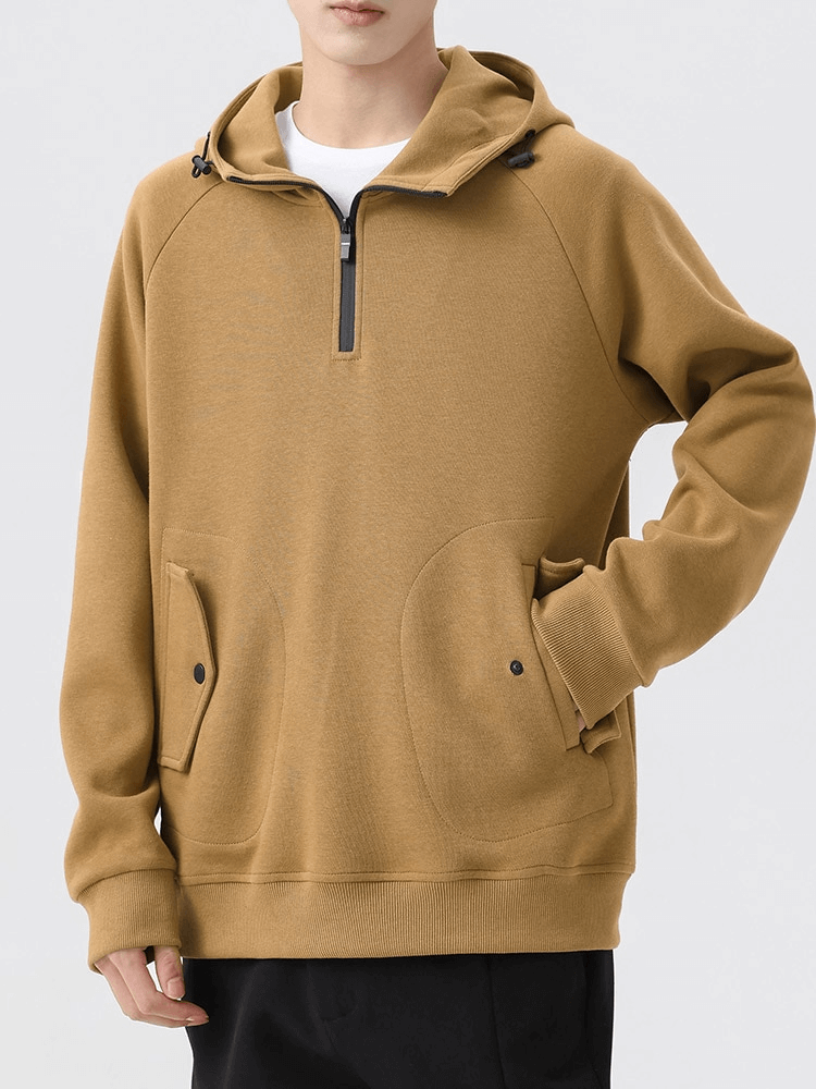 Men's khaki half-zip hoodie with long sleeves and pockets, styled for comfort and fashion in a cotton-poly blend.