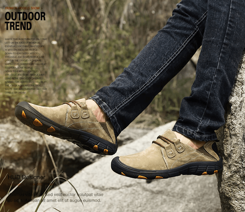 Man wearing breathable leather trekking shoes outdoors, showcasing durable design and superior traction on rocky terrain.