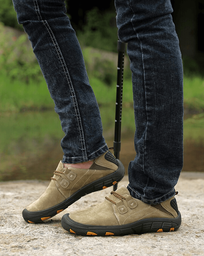 Man wearing fashionable breathable genuine leather trekking shoes outdoors