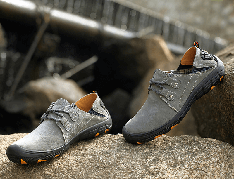 Fashion Male Breathable Genuine Leather Shoes - SF1344, grey outdoor trekking footwear on rocks, lace-up with rubber soles for secure fit.