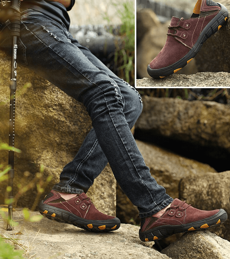 Man wearing Fashion Male Breathable Genuine Leather Shoes SF1344 during outdoor trekking with solid cow leather design.