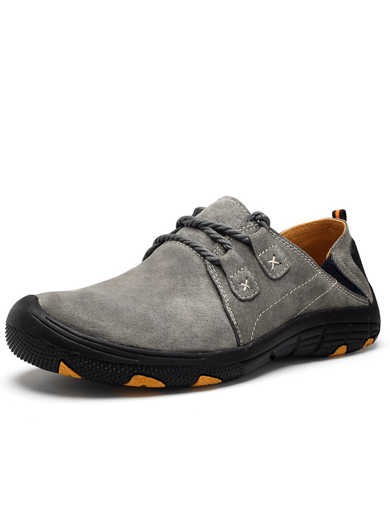 Grey genuine leather trekking shoes for men with lace-up closure and rubber outsole for outdoor adventures.