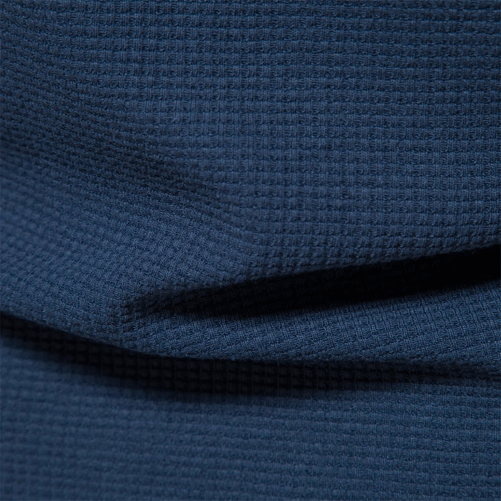 Close-up of navy blue waffle fabric texture for a solid color short sleeves T-shirt.
