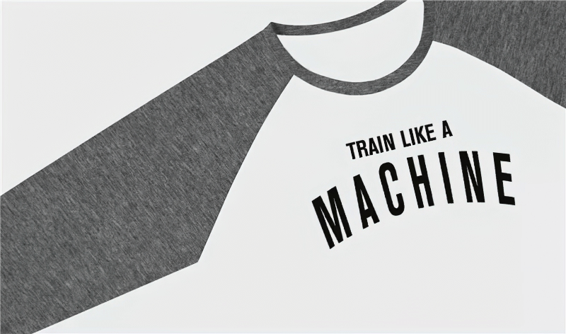Gray and white sports shirt with 'Train Like A Machine' text on front, featuring a round neckline and long sleeves.