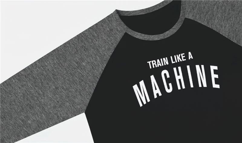 "Train Like a Machine" black and gray athletic shirt with long sleeves, perfect for workout sessions, emphasizing strength and durability.