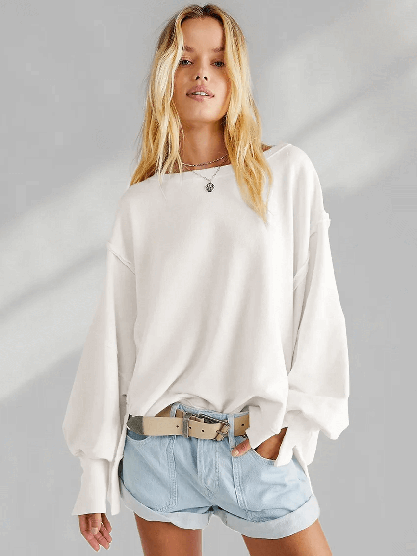 Fashion solid color drop shoulder loose sweatshirt, O-neck, three-quarter sleeves, worn by a woman with casual shorts and a belt.