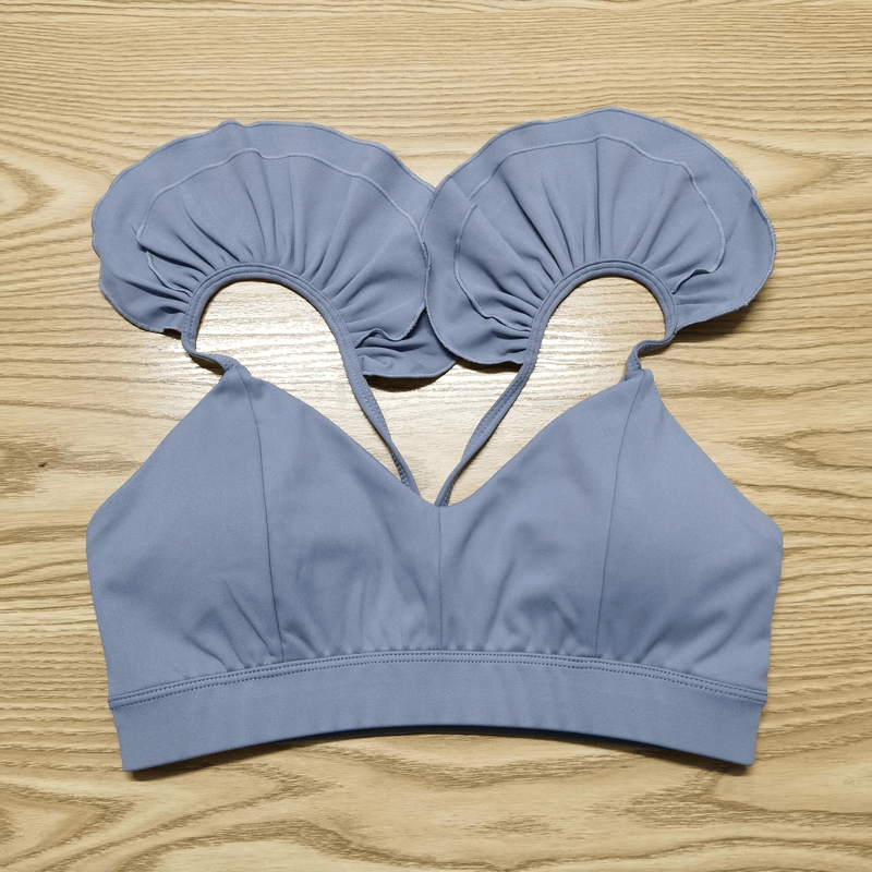 Fashion Solid Color Elastic Sports Bra for Women SF1740, perfect for yoga and running, shown on wooden background.