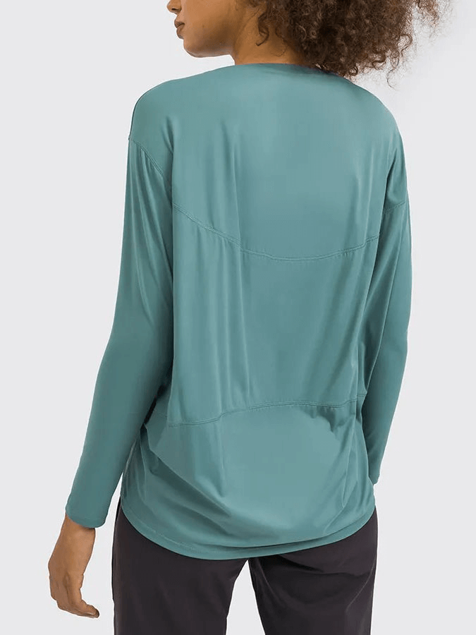 Back view of teal long sleeve workout top, perfect for gym sessions, featuring a loose fit and durable fabric blend.
