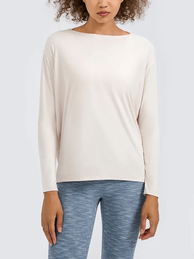 Woman wearing Fashion Solid Color Long Sleeves Loose Top for Gym, durable nylon-spandex, anti-pilling fabric, white.