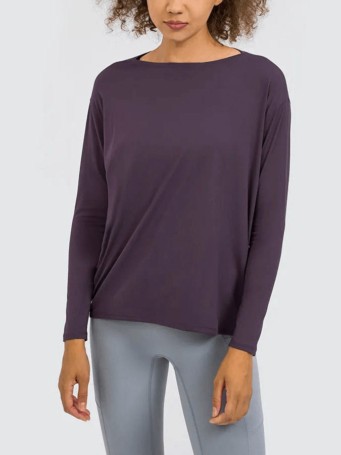 Women's solid color long sleeve loose gym top in dark purple, featuring breathable and durable fabric, perfect for workouts.