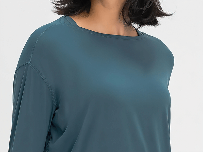 Fashion solid color long sleeves gym top in teal, durable nylon blend for workouts.