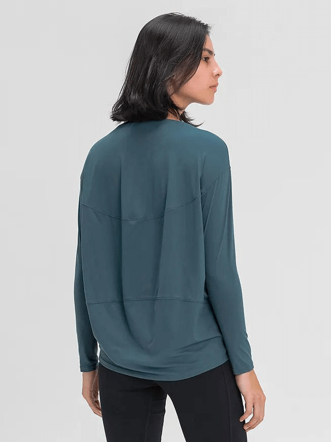Back view of a woman wearing a solid color, long sleeves loose top for gym, made from durable nylon-spandex blend, SF1821 in teal.