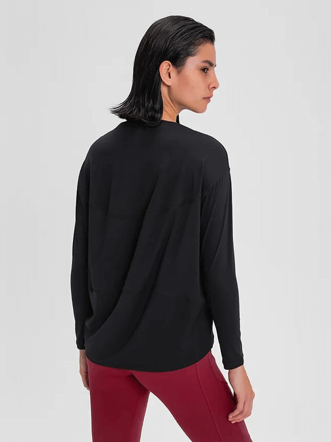 Model wearing black long sleeves loose top for gym, SF1821, made of quick-drying breathable fabric, shown from the back.
