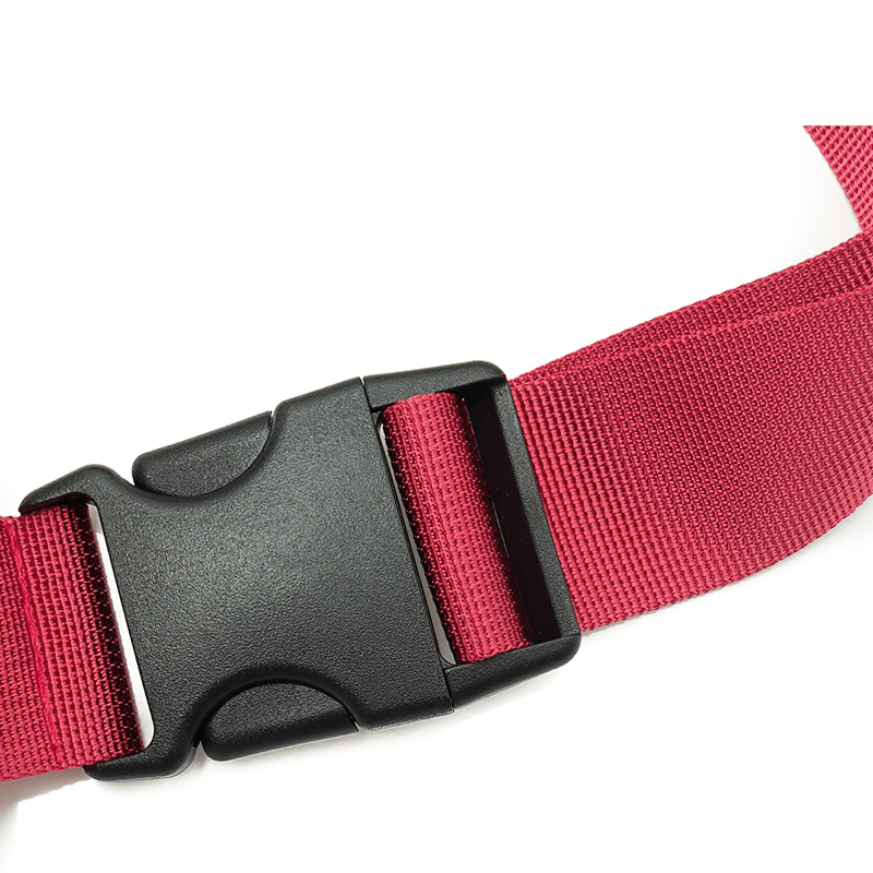Close-up of a black buckle on a red nylon adjustable belt from a fashion sports waist bag.