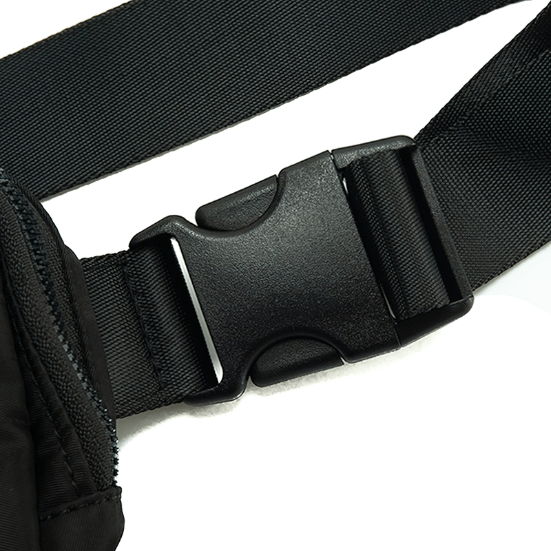 Close-up of black adjustable waist belt buckle on fashion sports multi-function waist bag for running, emphasizing durability and comfort.