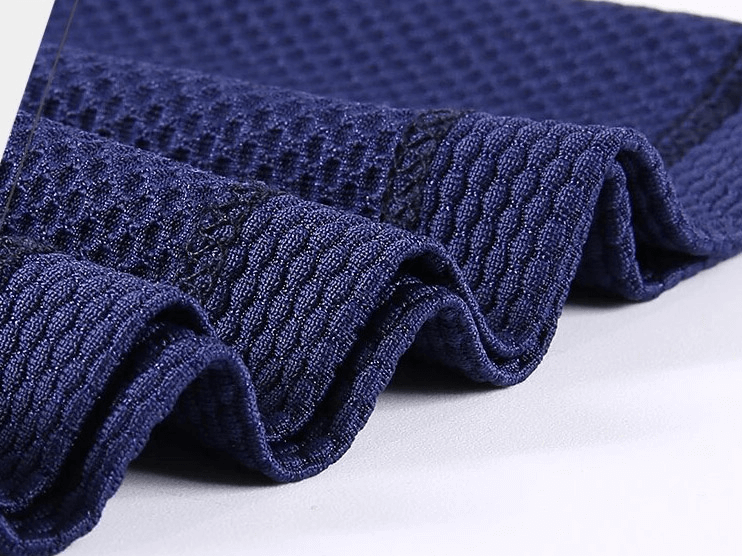 Close-up of navy blue breathable fabric for outdoor sports beanie, showcasing lightweight polyester material and texture.