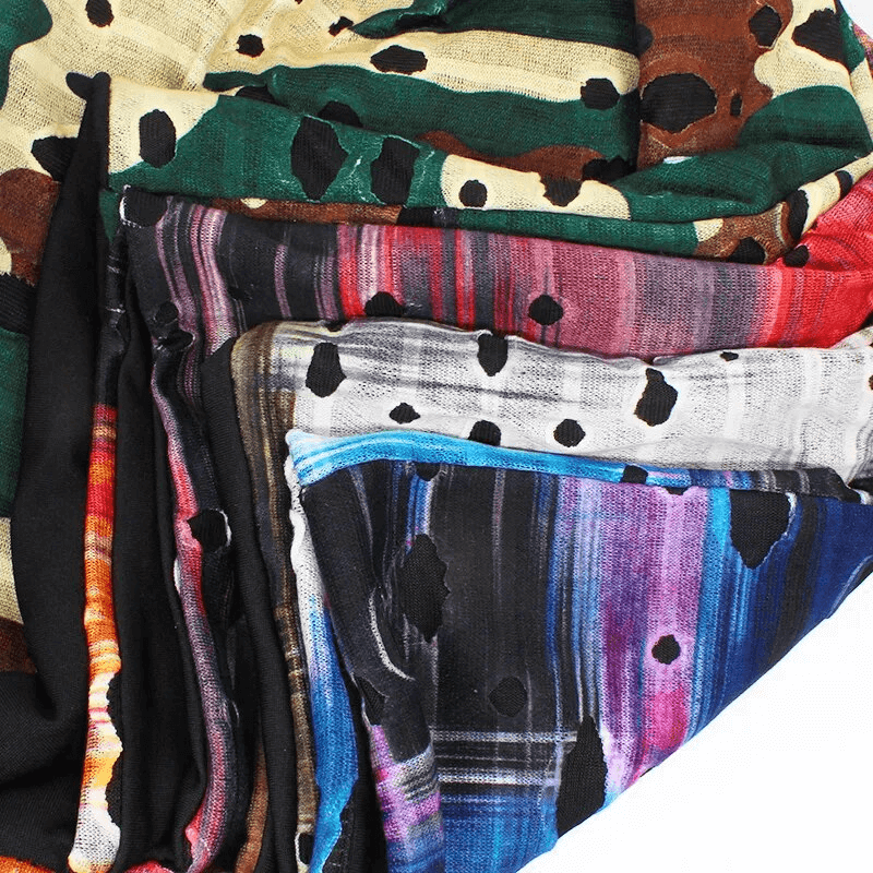 Colorful geometric patterned polyester fabric with holes, showcasing vibrant and diverse designs ideal for fashion accessories.