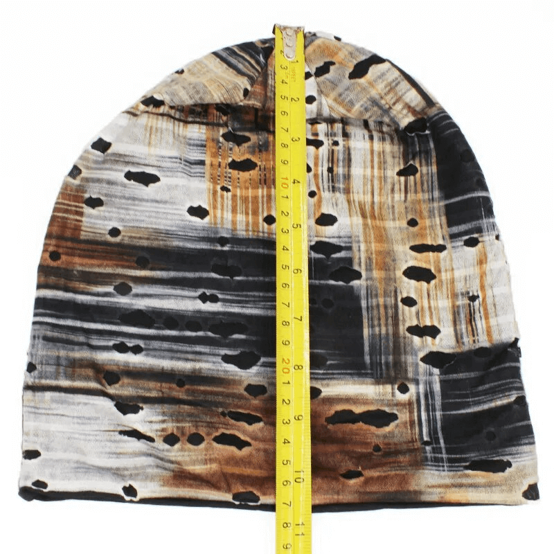 Fashion warm thin baggy beanie with holes featuring a geometric pattern, measuring with a yellow tape measure, unisex and stylish.
