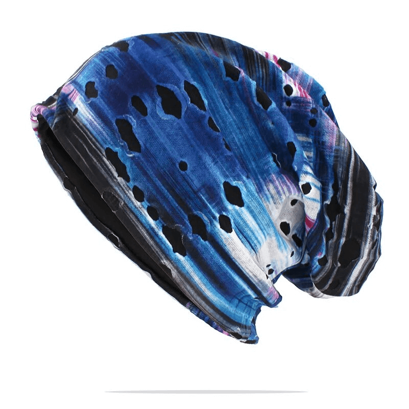 Fashionable blue baggy beanie with geometric holes, made of polyester. Unisex design perfect for keeping warm in casual settings.