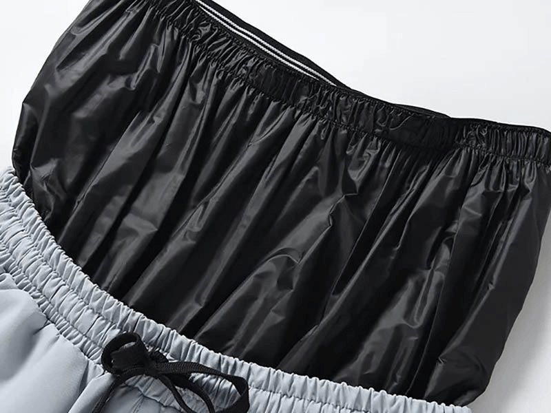 Close-up of black and grey windproof waterproof snowboarding pants waistband and drawstring