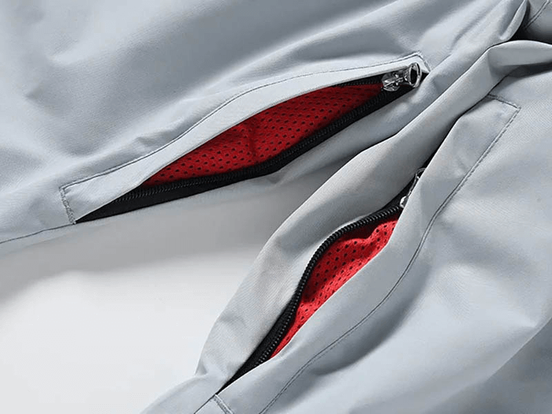 Close-up of windproof and waterproof snowboarding pants SF1842 with zipper pockets and red lining for extra warmth.