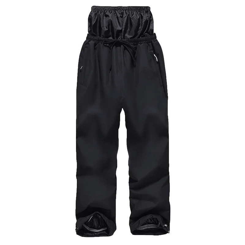Unisex black snowboarding pants, windproof and waterproof, with zipper fly closure and full-length design for winter sports.
