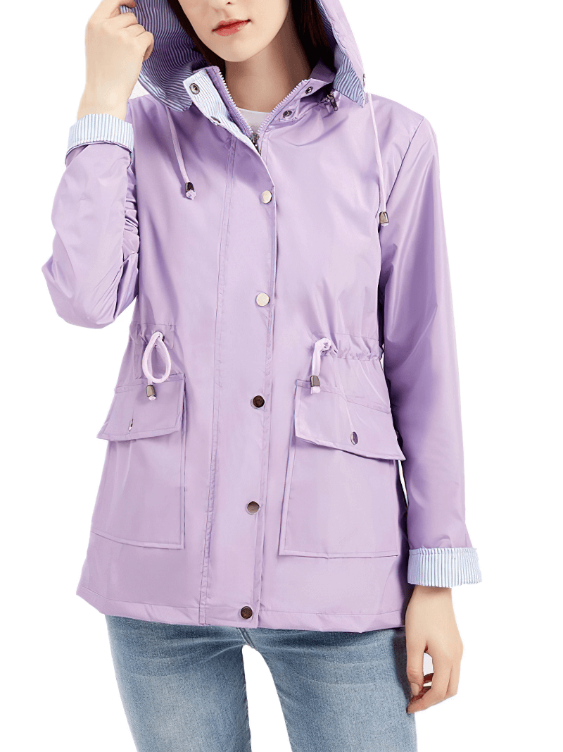 Woman wearing a lilac waterproof trench coat with detachable hood, featuring full sleeves, mandarin collar, and front pockets.